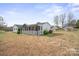 Expansive backyard with lawn, mature trees, and partially screened in patio at 3966 Peach St # 56, Newton, NC 28658
