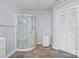 Well-lit bathroom with glass shower, storage cabinet, and tile floors at 3966 Peach St # 56, Newton, NC 28658