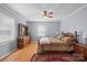 Traditional bedroom features hardwood floors, a ceiling fan, and a large dresser at 3966 Peach St # 56, Newton, NC 28658