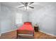 Cozy bedroom featuring wood-look flooring, a ceiling fan and a bright window at 3966 Peach St # 56, Newton, NC 28658