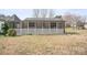 Quaint home featuring a cozy screened front porch with white lattice details at 3966 Peach St # 56, Newton, NC 28658
