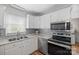 Modern kitchen with stainless steel appliances, granite countertops, and ample cabinet space at 3966 Peach St # 56, Newton, NC 28658