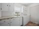 Well-lit laundry area featuring a washer, dryer, and ample storage cabinets at 3966 Peach St # 56, Newton, NC 28658