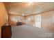 Well-lit living room features a neutral carpet, desk space, and door to the exterior at 3966 Peach St # 56, Newton, NC 28658