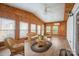 Bright sunroom with wood paneled walls, perfect for relaxing, with cozy wicker furniture at 3966 Peach St # 56, Newton, NC 28658