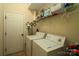 Efficient laundry room with appliances and storage space, adjacent to a convenient door at 4006 Hickory View Dr, Fort Mill, SC 29707