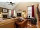 Cozy living room with a fireplace, vaulted ceilings, and large windows at 4006 Hickory View Dr, Fort Mill, SC 29707