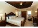 Spacious main bedroom features a trey ceiling, a ceiling fan, an armoire and large windows with curtains at 4006 Hickory View Dr, Fort Mill, SC 29707