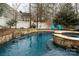 Backyard pool with a built-in spa and stone accents at 4006 Hickory View Dr, Fort Mill, SC 29707