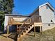 Exterior view of the back wooden deck with stairs to the ground and light siding at 44 Fenix Sw Dr, Concord, NC 28025