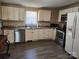 Well-lit kitchen featuring white cabinets, stainless steel appliances, and modern countertops at 44 Fenix Sw Dr, Concord, NC 28025