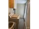 Functional laundry area features cabinets above machines and neutral walls and flooring at 44 Fenix Sw Dr, Concord, NC 28025