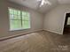 Well-lit bedroom boasts a large window, a ceiling fan, and plush carpeting for ultimate relaxation at 4586 Antelope Ln, Charlotte, NC 28269