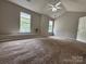 Bright bedroom with neutral carpeting, two windows, and a ceiling fan creates a peaceful retreat at 4586 Antelope Ln, Charlotte, NC 28269