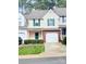 Charming townhouse featuring neutral siding, green shutters, and a one-car garage nestled in a tree-lined community at 4586 Antelope Ln, Charlotte, NC 28269