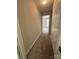 Hallway leads to a bright room with carpeting and white trim, creating a sense of flow and connection at 4586 Antelope Ln, Charlotte, NC 28269