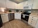 Bright eat-in kitchen features stainless steel appliances, white cabinets, and tile floors at 4586 Antelope Ln, Charlotte, NC 28269