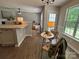Open-concept living room features hardwood floors, a kitchen island, and natural light at 4586 Antelope Ln, Charlotte, NC 28269