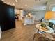Open-concept living room features hardwood floors, a kitchen island, and natural light at 4586 Antelope Ln, Charlotte, NC 28269