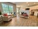 Bright open-concept living area features neutral paint, wood floors, and access to the kitchen at 4586 Antelope Ln, Charlotte, NC 28269