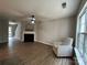 Inviting living room with fireplace, ceiling fan, and natural light at 4586 Antelope Ln, Charlotte, NC 28269