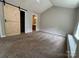 Spacious carpeted bedroom features a barn-style sliding door and ensuite bath at 4586 Antelope Ln, Charlotte, NC 28269