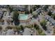 Aerial view of community pool featuring lounge chairs, mature trees, and surrounding residential area at 4586 Antelope Ln, Charlotte, NC 28269