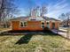 Quaint backyard with a brick home, a manicured lawn, and mature trees at 4808 Cedar Ct, Gastonia, NC 28056