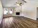 Bright living room featuring a stone fireplace, windows, and light, airy atmosphere with hardwood floors at 4808 Cedar Ct, Gastonia, NC 28056