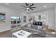 Bright living room with hardwood floors, ceiling fan, and sliding door access to the outdoor patio at 5348 Crouse Rd, Crouse, NC 28033