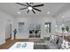 Bright living room featuring hardwood floors, a modern ceiling fan, and sliding door access to the outdoor patio at 5348 Crouse Rd, Crouse, NC 28033