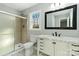 Bathroom featuring a white vanity with marble countertop and framed mirror, plus a glass-enclosed shower at 5717 Ruth Dr, Charlotte, NC 28215