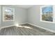Bright bedroom with windows, wood-look flooring, and fresh paint at 5717 Ruth Dr, Charlotte, NC 28215