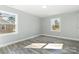 Large bedroom featuring two windows, luxury vinyl plank flooring, and fresh paint at 5717 Ruth Dr, Charlotte, NC 28215