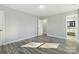 Well-lit bedroom featuring luxury vinyl plank flooring, fresh paint and easy access to the bathroom at 5717 Ruth Dr, Charlotte, NC 28215