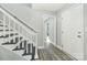 Inviting entryway with freshly painted gray walls and white trim with newly installed floors and a staircase at 5717 Ruth Dr, Charlotte, NC 28215