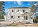 Rear exterior view of the white brick house with covered porch and patio at 5717 Ruth Dr, Charlotte, NC 28215