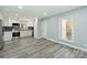 Bright kitchen with stainless steel appliances, new gray backsplash and white cabinetry, and modern flooring at 5717 Ruth Dr, Charlotte, NC 28215