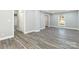 Spacious living room with durable wood-look flooring, fresh paint, and natural light at 5717 Ruth Dr, Charlotte, NC 28215