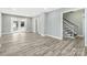 The Living room is open and bright, featuring modern flooring, fresh paint and trim, and multiple access points at 5717 Ruth Dr, Charlotte, NC 28215