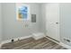 Utility room features luxury vinyl plank flooring, access to the exterior and fresh paint at 5717 Ruth Dr, Charlotte, NC 28215