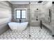 A luxurious bathroom featuring a freestanding tub, glass enclosed shower, and hexagon patterned floor at 5834 Five Knolls Dr, Charlotte, NC 28226