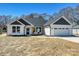 Charming, single-story home featuring a neutral color palette, attached garage and a manicured lawn at 603 N Elm St, Cherryville, NC 28021