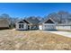 Charming one-story home featuring white siding, a two-car garage, and a well-manicured lawn on a clear, sunny day at 603 N Elm St, Cherryville, NC 28021
