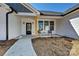 Inviting front porch area featuring sleek pillars, a black door, and a cozy spot to relax at 603 N Elm St, Cherryville, NC 28021