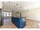 Bright open kitchen featuring a blue island with stone countertop and modern lighting at 603 N Elm St, Cherryville, NC 28021