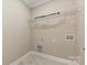 Clean laundry room includes shelving for extra storage at 603 N Elm St, Cherryville, NC 28021
