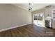 Living room featuring wood flooring, modern lighting, and backyard access at 603 N Elm St, Cherryville, NC 28021