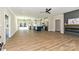 An open-concept living room featuring a fireplace, ceiling fan, and seamless access to the kitchen at 603 N Elm St, Cherryville, NC 28021
