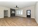 Living area with modern fireplace, ceiling fan, and large windows at 603 N Elm St, Cherryville, NC 28021